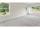 Spacious bedroom with large windows, natural light, and neutral carpeting for a cozy feel at 3315 Hillshire Dr, Cumming, GA 30028