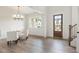 Bright dining room showcasing wood floors, a decorative light fixture, and paneled accent walls at 3315 Hillshire Dr, Cumming, GA 30028