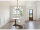 Well-lit dining room with wood floors, a chandelier, a round table, and large windows at 3315 Hillshire Dr, Cumming, GA 30028