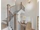 Open foyer with staircase, wood railing, and a view into a dining area at 3315 Hillshire Dr, Cumming, GA 30028