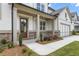 Elegant home entrance featuring a charming front porch with brick accents and a wooden front door at 3315 Hillshire Dr, Cumming, GA 30028