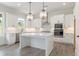Modern kitchen featuring white cabinets, stainless steel appliances, and a large center island at 3315 Hillshire Dr, Cumming, GA 30028