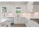 Modern kitchen with white cabinets, stainless steel appliances, and a view from the window at 3315 Hillshire Dr, Cumming, GA 30028