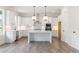 Modern kitchen with white cabinetry, stainless steel appliances, a central island, and hardwood floors at 3315 Hillshire Dr, Cumming, GA 30028