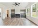 Open living space with built-in shelving, fireplace, expansive windows, and wood flooring at 3315 Hillshire Dr, Cumming, GA 30028