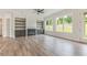 Spacious living room with wood floors, a fireplace, built-in shelves, and large windows at 3315 Hillshire Dr, Cumming, GA 30028