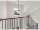 Elegant staircase with dark iron railings and a modern light fixture at 3315 Hillshire Dr, Cumming, GA 30028