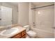 Bright bathroom features a combination shower-tub, toilet, and vanity with a sink at 3320 Gardenside Dr, Loganville, GA 30052