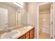 Bathroom with double sink vanity, large mirror, and separate shower/tub area at 3320 Gardenside Dr, Loganville, GA 30052