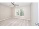 Bedroom with ceiling fan, window, and neutral colored carpet at 3320 Gardenside Dr, Loganville, GA 30052