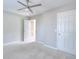 Neutral bedroom with carpet, ceiling fan and white door at 3320 Gardenside Dr, Loganville, GA 30052