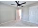 Comfortable bedroom featuring plush carpet, ample natural light, and a modern ceiling fan at 3320 Gardenside Dr, Loganville, GA 30052