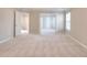 Spacious primary bedroom with neutral carpet and doorway access to additional rooms at 3320 Gardenside Dr, Loganville, GA 30052