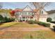 Charming two-story home featuring a well-manicured lawn and a classic brick facade with a two-car garage at 3320 Gardenside Dr, Loganville, GA 30052