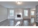 Bright living room with a classic fireplace, hardwood floors, and large windows offering plenty of natural light at 3320 Gardenside Dr, Loganville, GA 30052