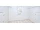 Walk-in closet features neutral carpet and window for natural light at 3320 Gardenside Dr, Loganville, GA 30052