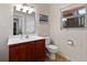 Cozy bathroom featuring a vanity with storage, a toilet, and a window for natural light at 113 Brittany Ct, Duluth, GA 30096