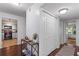 Bright entryway with hardwood floors, white closets, and sightlines to the kitchen and bedroom at 113 Brittany Ct, Duluth, GA 30096