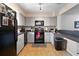 Functional kitchen features neutral cabinets, black appliances, and tiled floors at 113 Brittany Ct, Duluth, GA 30096