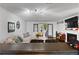 Cozy living room with modern track lighting, white walls, and a fireplace; open to the dining area at 113 Brittany Ct, Duluth, GA 30096