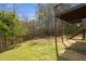 Backyard featuring a wooden deck with stairs, set against a backdrop of mature trees, offering a serene outdoor space at 209 Emma Gilley Dr, Carrollton, GA 30116