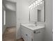 A modern bathroom featuring a well-lit vanity with a sleek faucet and fixtures at 209 Emma Gilley Dr, Carrollton, GA 30116