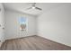 Sunlit bedroom with modern ceiling fan and large window offering a pleasant view at 209 Emma Gilley Dr, Carrollton, GA 30116