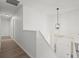 Bright hallway features hardwood floors, white walls, and a modern light fixture at 209 Emma Gilley Dr, Carrollton, GA 30116