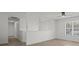 Hallway features hardwood floors, white walls, with a modern light fixture and large window at 209 Emma Gilley Dr, Carrollton, GA 30116