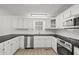 A spacious kitchen features white cabinets and stainless steel appliances at 209 Emma Gilley Dr, Carrollton, GA 30116