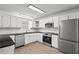 A spacious kitchen features white cabinets and stainless steel appliances at 209 Emma Gilley Dr, Carrollton, GA 30116