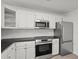A spacious kitchen features white cabinets and stainless steel appliances at 209 Emma Gilley Dr, Carrollton, GA 30116