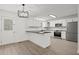 Bright kitchen with white cabinets, stainless steel appliances, and an island with black countertop at 209 Emma Gilley Dr, Carrollton, GA 30116