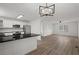 Pristine kitchen with white cabinetry and modern appliances seamlessly connected to the living space at 209 Emma Gilley Dr, Carrollton, GA 30116