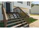 Wooden staircase with railings leading to the front entrance, showcasing meticulous construction at 209 Emma Gilley Dr, Carrollton, GA 30116