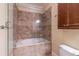 Bathroom including a glass shower, soaking tub, and tiled walls at 3635 E Paces Ne Cir # 1209, Atlanta, GA 30326