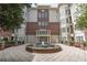 Beautifully landscaped courtyard with a fountain, flowering plants, and benches creating a welcoming entrance at 3635 E Paces Ne Cir # 1209, Atlanta, GA 30326