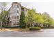 Attractive multi-story condo building featuring lush landscaping and mature trees on a tree lined street at 3635 E Paces Ne Cir # 1209, Atlanta, GA 30326