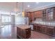 Gourmet kitchen with dark wood cabinets, stainless steel appliances, and granite countertops island at 3635 E Paces Ne Cir # 1209, Atlanta, GA 30326
