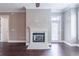 Living room with fireplace, hardwood flooring, and a back door that provides plenty of sunlight at 3635 E Paces Ne Cir # 1209, Atlanta, GA 30326