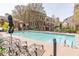 Resort-style community pool with lounge chairs and manicured landscaping in a luxurious neighborhood at 3635 E Paces Ne Cir # 1209, Atlanta, GA 30326