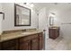 Spacious bathroom with double vanity featuring granite counter, framed mirror, and tile floor at 5925 Pine Bluff Dr, Cumming, GA 30040