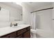 Well-lit bathroom with a dark wood vanity, white countertops, and a shower-tub combination at 5925 Pine Bluff Dr, Cumming, GA 30040