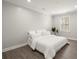Cozy bedroom featuring a white duvet cover, neutral walls, and a bright window at 5925 Pine Bluff Dr, Cumming, GA 30040