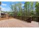 Spacious wood deck offers outdoor living space with scenic views of surrounding trees and greenery at 5925 Pine Bluff Dr, Cumming, GA 30040