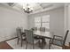 Elegant dining room featuring a coffered ceiling, chandelier, and natural light from a window at 5925 Pine Bluff Dr, Cumming, GA 30040