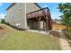 Back of home featuring a wood deck, walk out basement and rock lined border at 5925 Pine Bluff Dr, Cumming, GA 30040