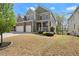 Charming two-story home featuring a stone facade, two-car garage, and a welcoming front porch at 5925 Pine Bluff Dr, Cumming, GA 30040