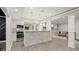 Modern kitchen with white cabinets, stainless steel appliances, and a stone-clad bar area at 5925 Pine Bluff Dr, Cumming, GA 30040