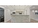 Stylish kitchen with stainless appliances, mirrored backsplash, stone-clad bar, and modern lighting at 5925 Pine Bluff Dr, Cumming, GA 30040